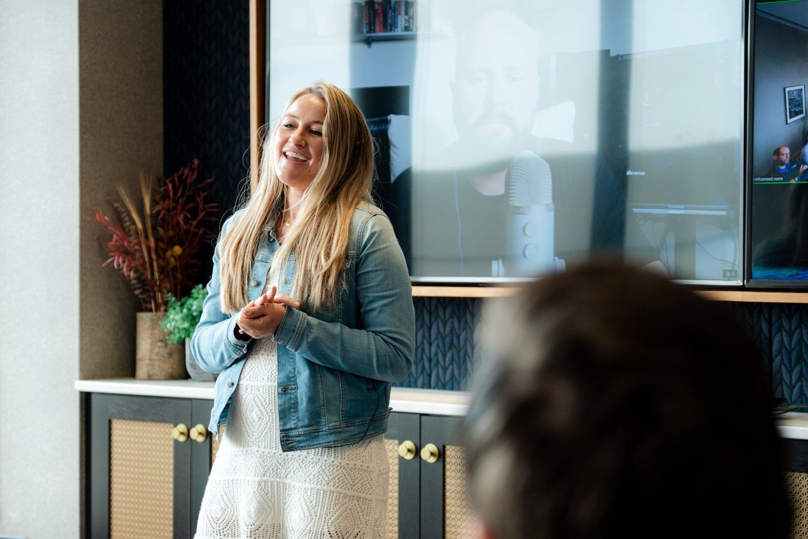 A presenter laughs with the audience at a Chipp event